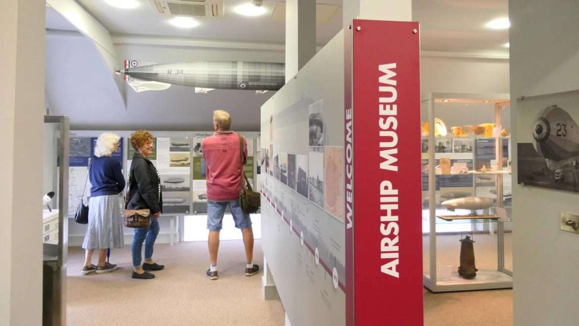 Visitors exploring the Airship Museum exhibition at The Pennoyer Centre, with interpretation panels and museum displays highlighting local aviation history.