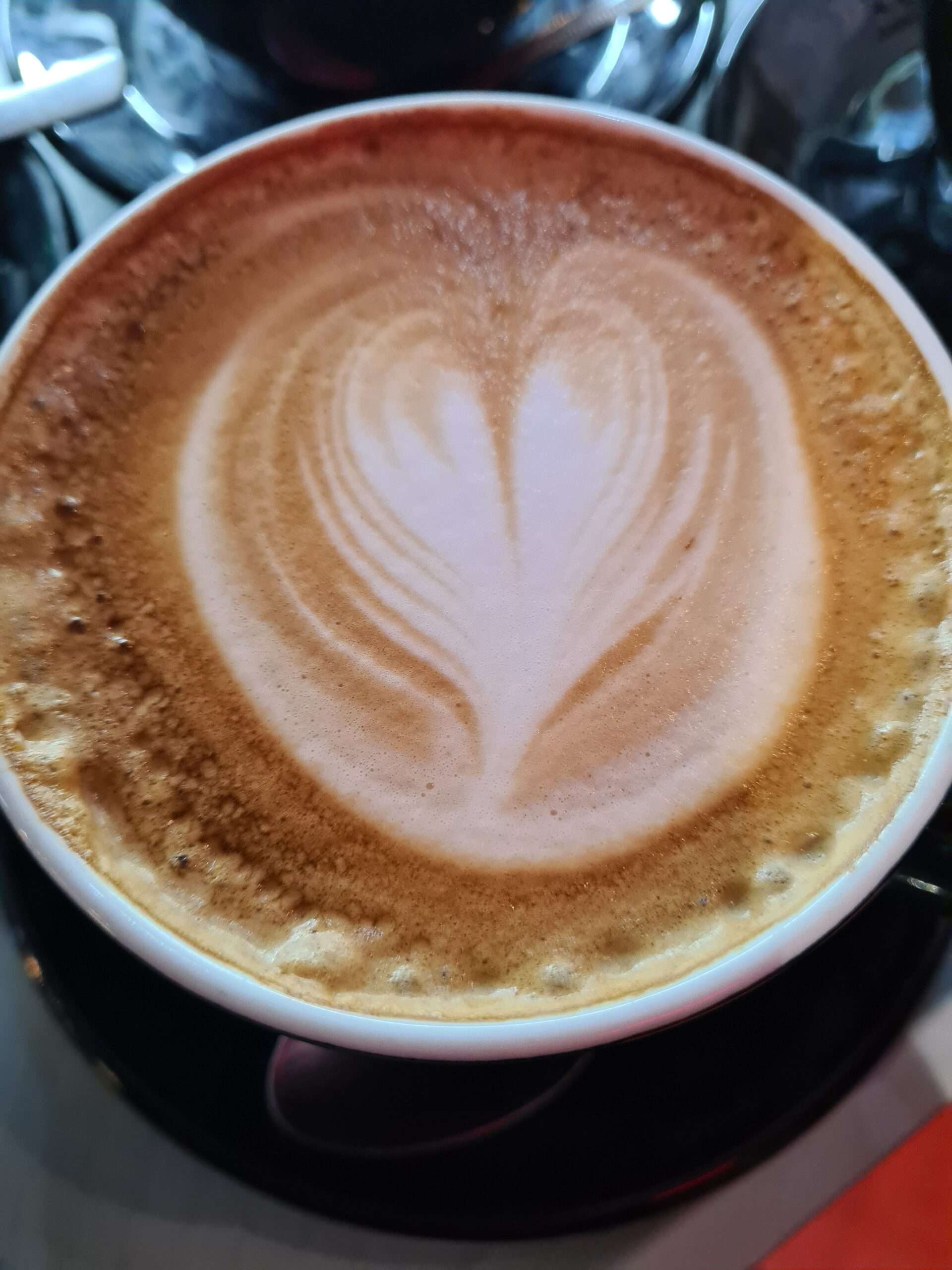 Freshly made latte with heart-shaped latte art served at Time Out Coffee and Food, Diss.