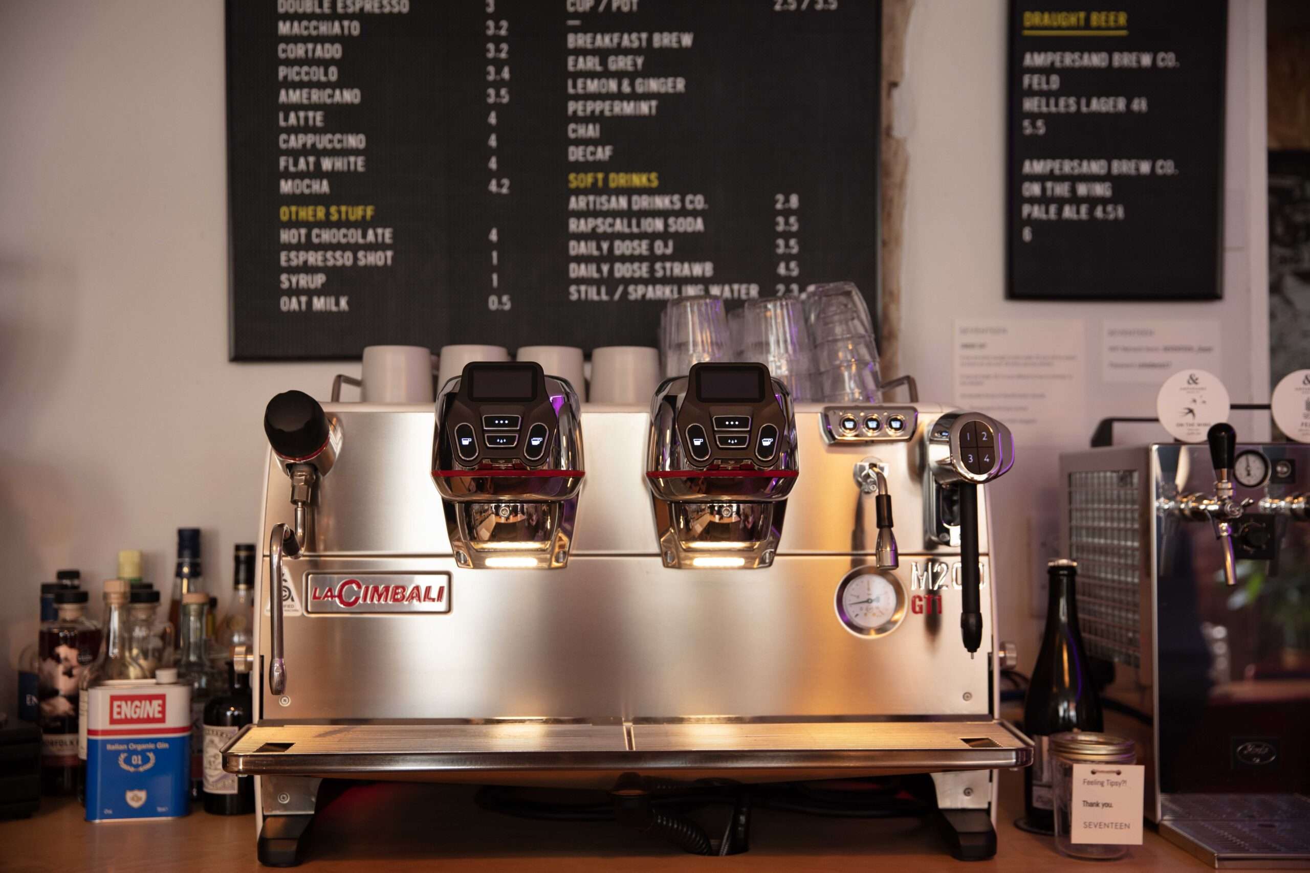 Coffee machine and drinks menu behind the bar at Bar 44, showcasing the café and bar service.