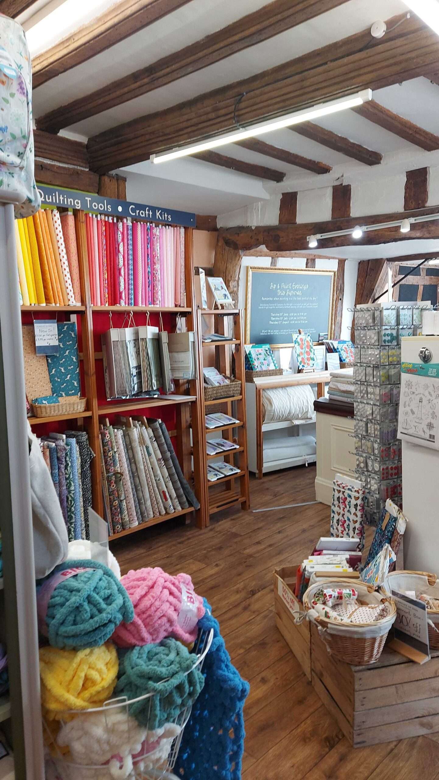Interior of Albright of Diss showing fabric displays, haberdashery supplies and craft materials.