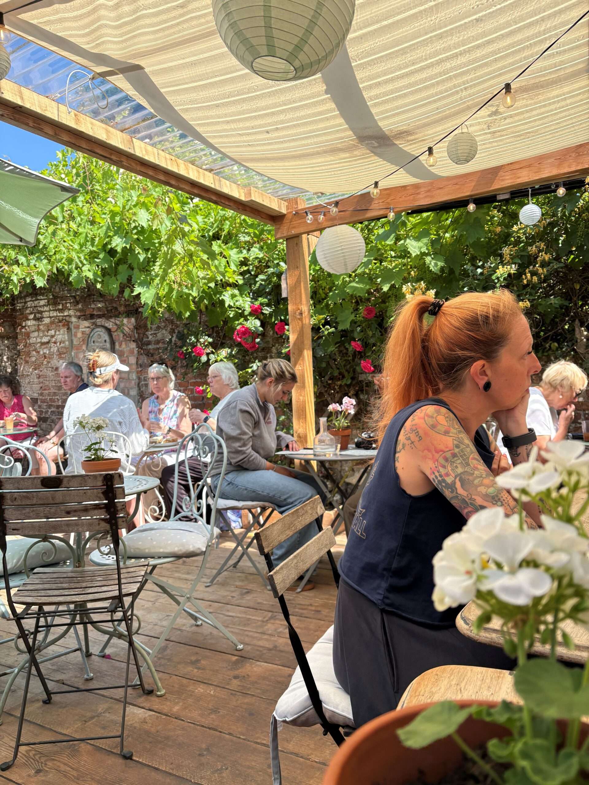 SOUL Café's unique courtyard garden with outdoor seating beneath a covered canopy, providing a sheltered, dog-friendly space to relax and dine throughout the year.