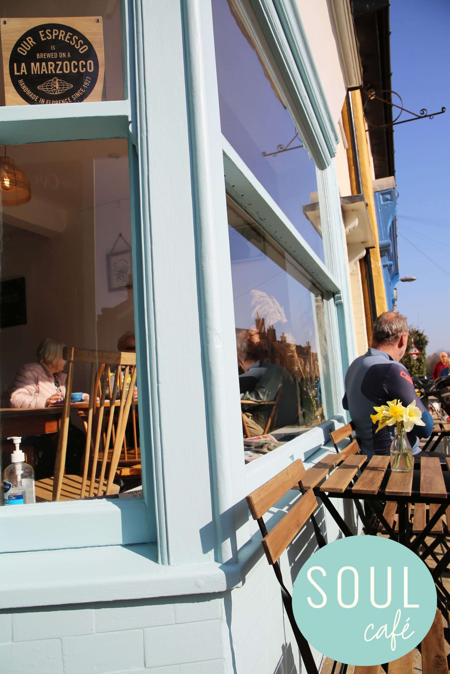 Outdoor seating area at SOUL Café with tables beside the café frontage, offering alfresco dining in the heart of Harleston.