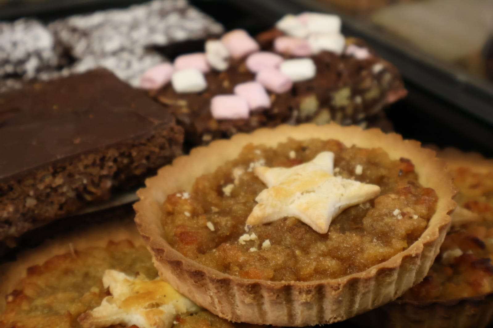 Selection of homemade sweet treats including fruit tart, chocolate cake and iced traybake at Diane’s Pantry.
