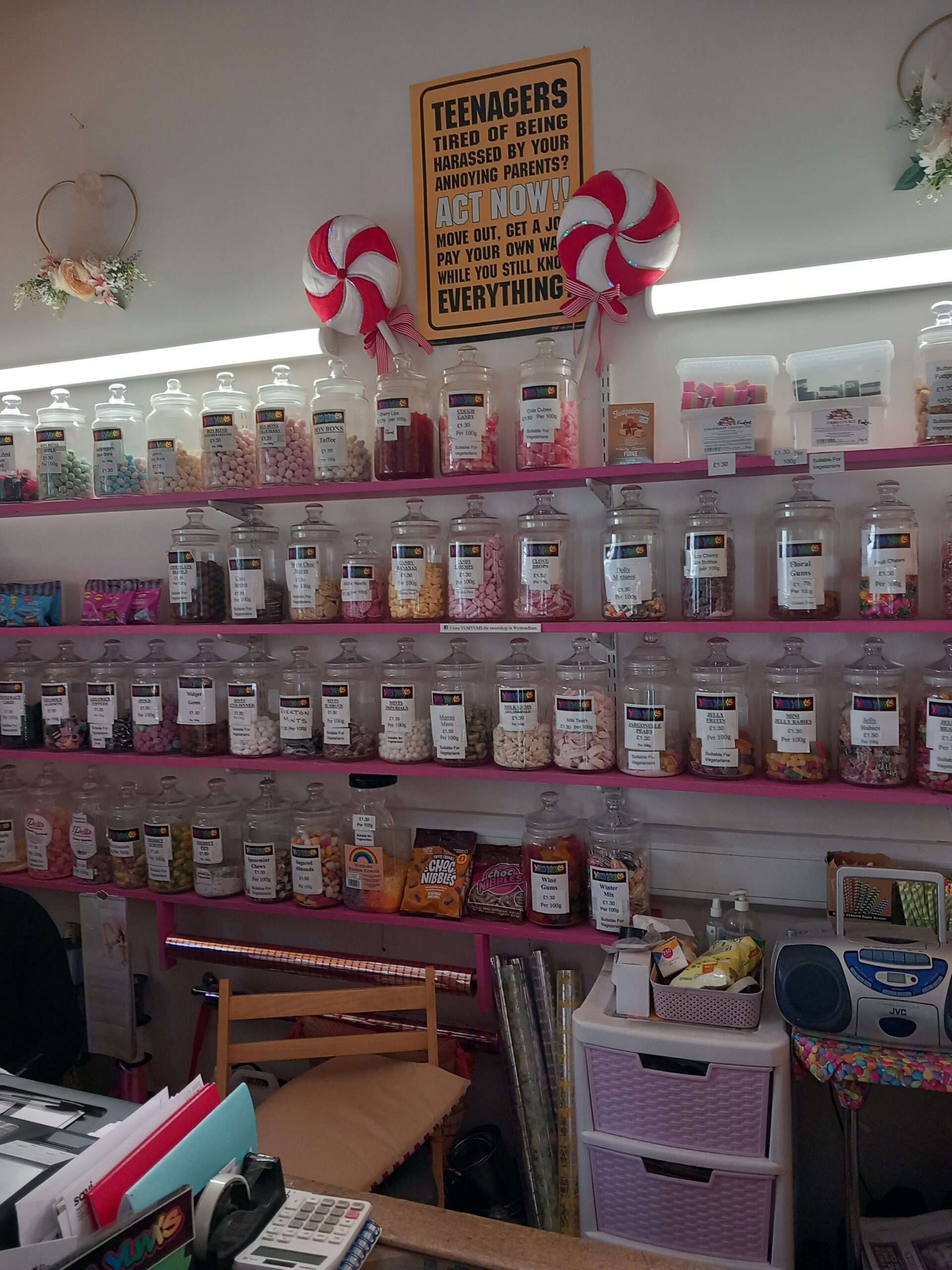 Display of traditional sweets and confectionery jars arranged on shop shelves.