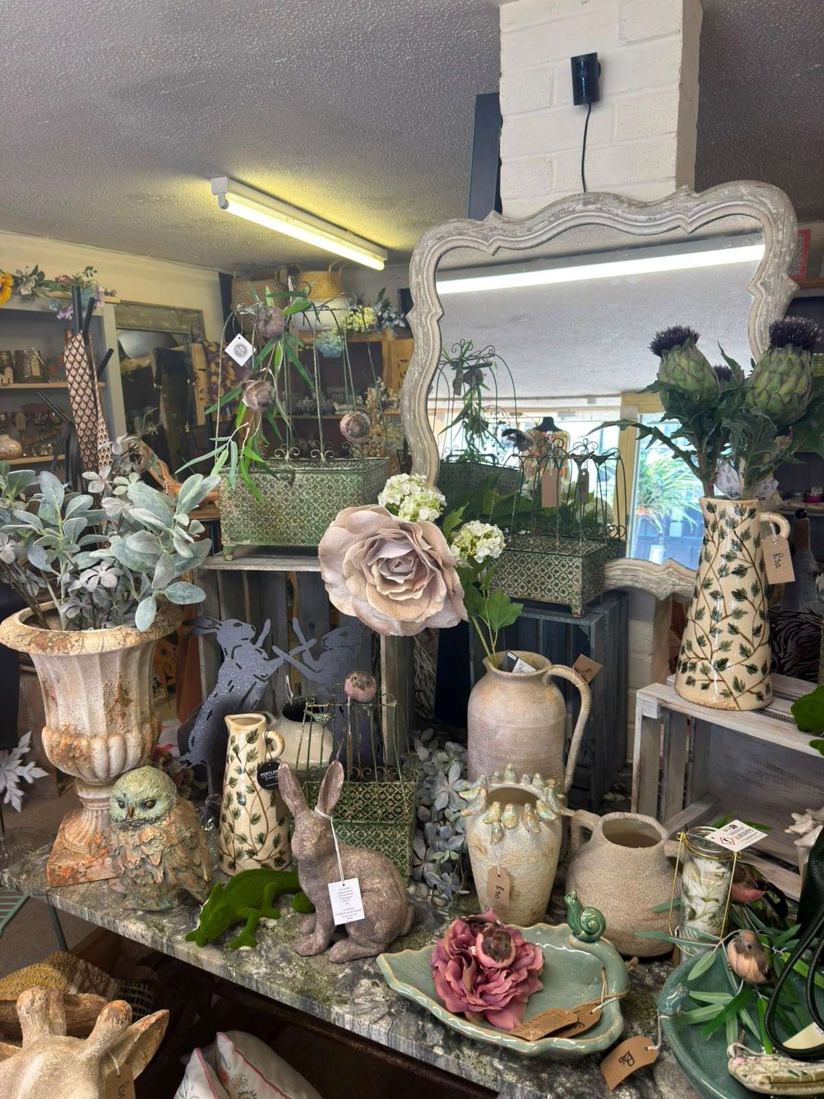 Stylish interior display at Ebony Interiors featuring home décor, plants, mirrors, gifts and fashion accessories.