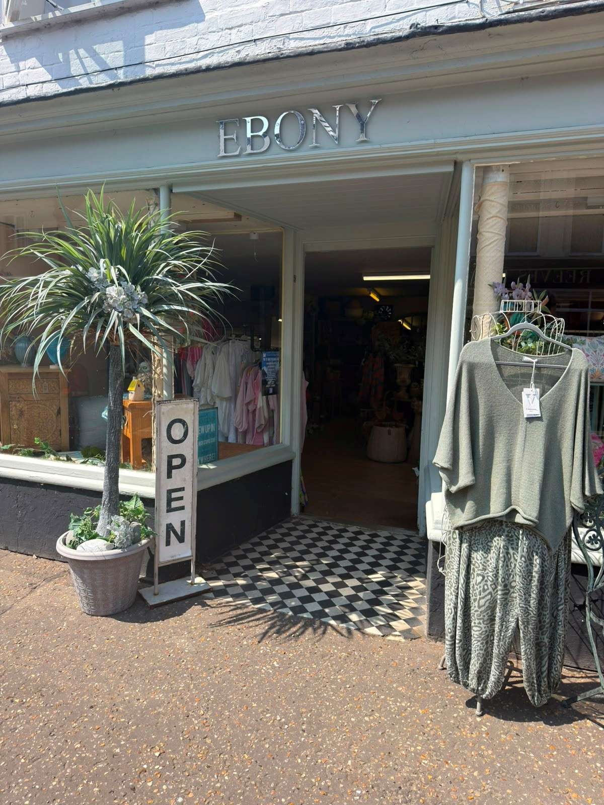 Entrance to Ebony Interiors in Wymondham, showcasing women's clothing, accessories and boutique displays outside the shop.
