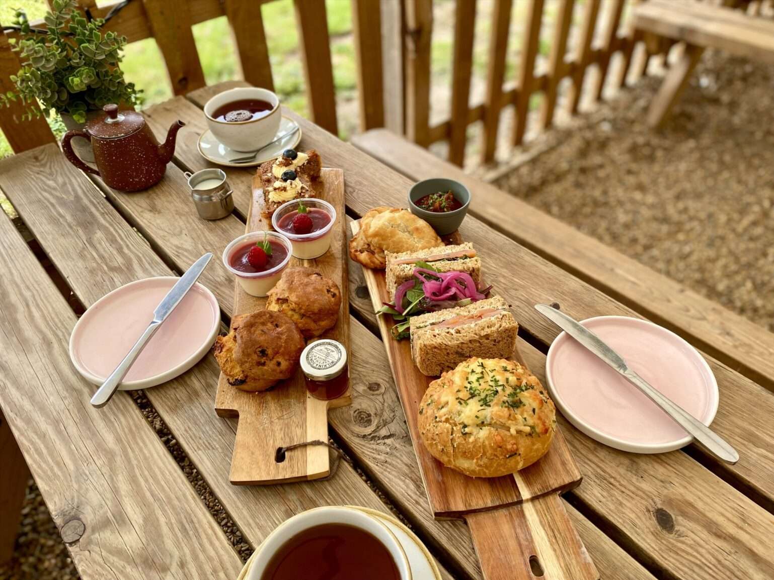 Breakfast spread with coffee, pastries, preserves and fresh food served on an outdoor table at the Goat Shed