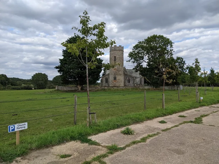 Haveringland Church from a distance showing the driveway and large sky