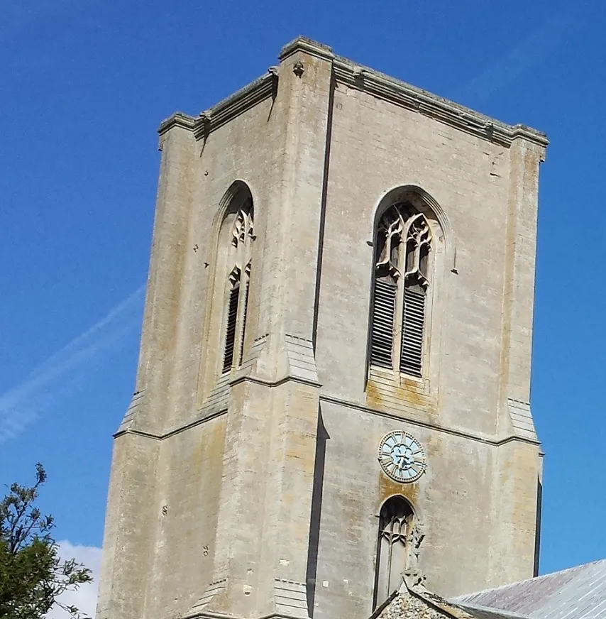 Historic church tower rising above the surrounding landscape in Norfolk.