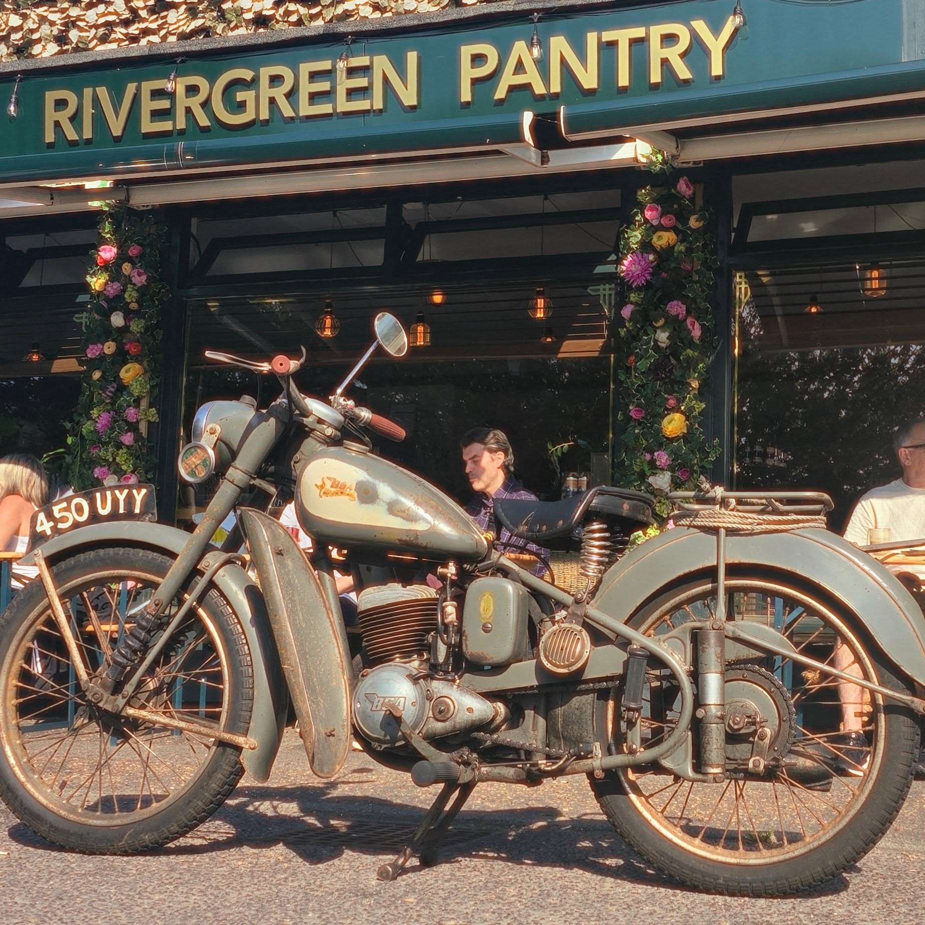 Exterior of River Green Pantry with motorbike, outdoor displays and colourful frontage in Norfolk.