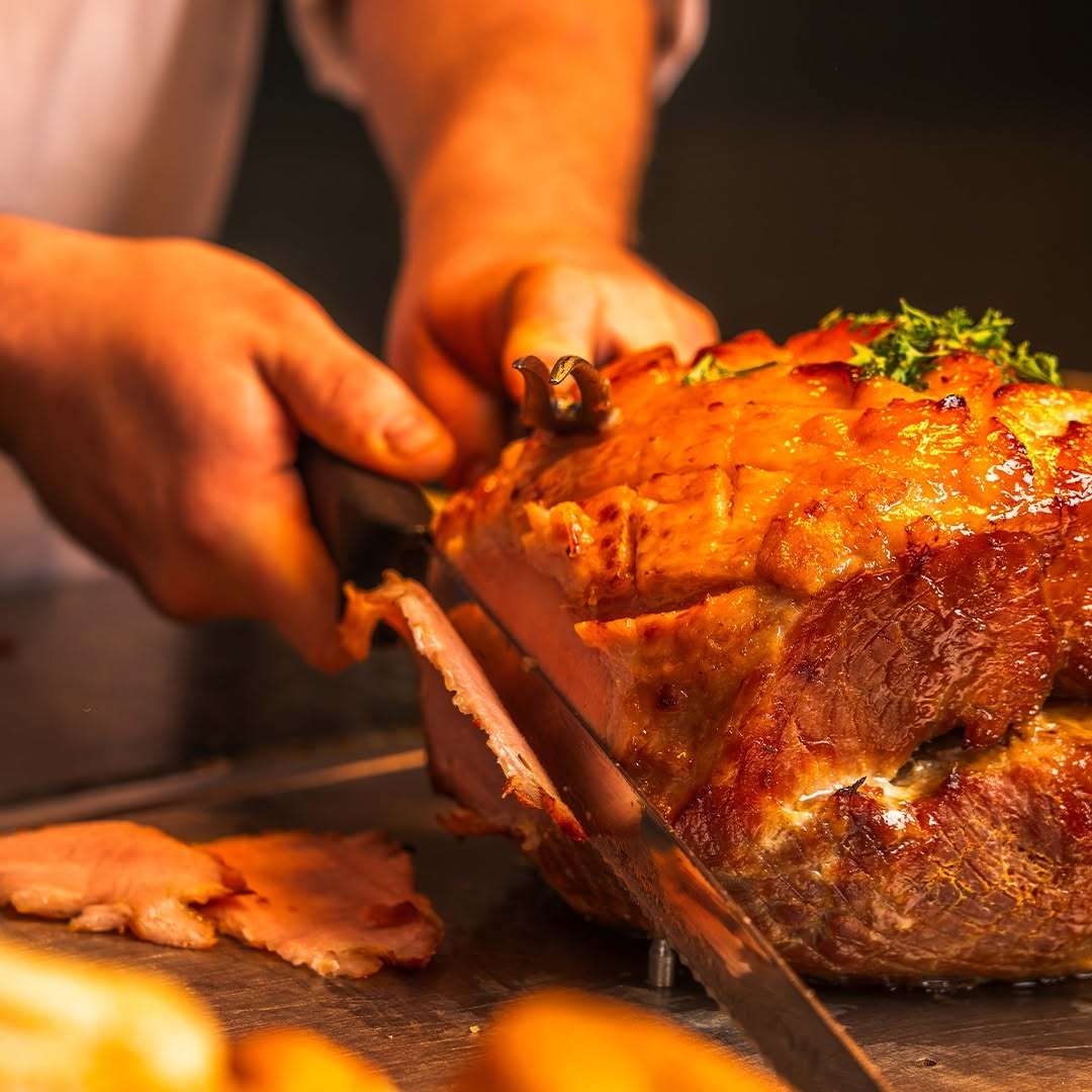 Chef carving freshly cooked roast meat at The Town House restaurant.