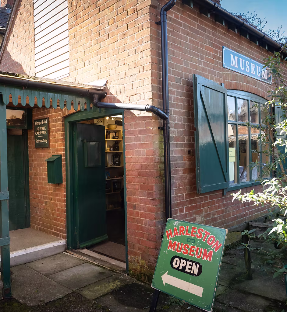 Exterior view of the Harleston and District Historical Society building, featuring a brick façade, entrance doorway and society signage welcoming visitors interested in local history.