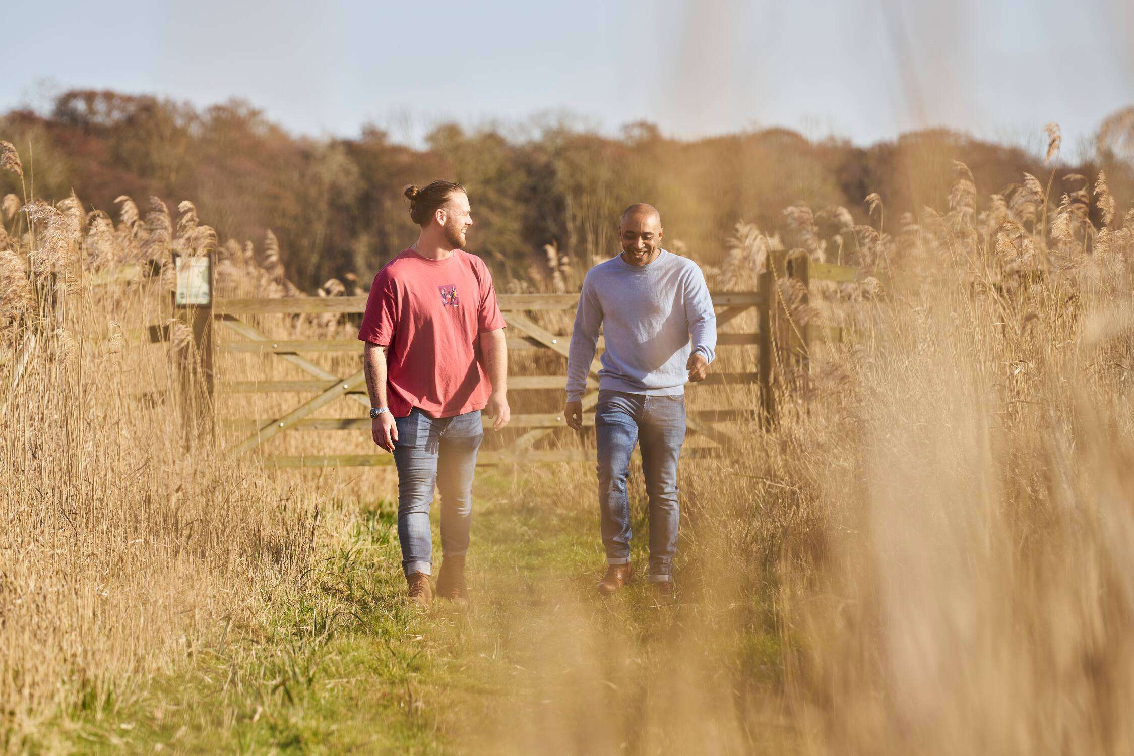 eople walking along a countryside path through an RSPB nature reserve Strumpshaw Fen